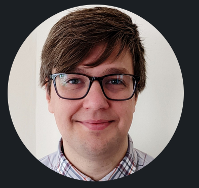 A photo of Harrison Hartley head-on from the neck up. He is wearing glasses.